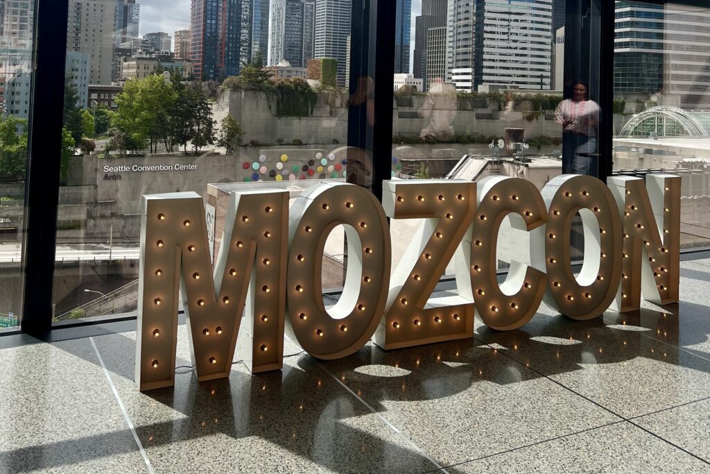 MozCon sign in front of a window overlooking the Seattle Convention Center